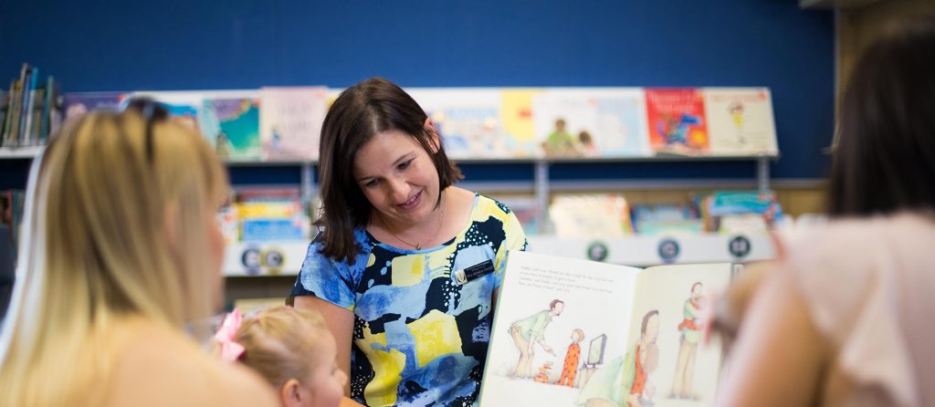 Teacher reading to young children